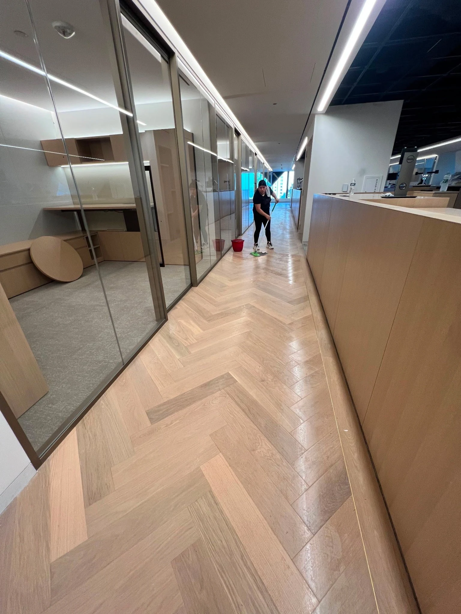 Close detail of the grain and herringbone pattern of a wood floor cared for by Luxor