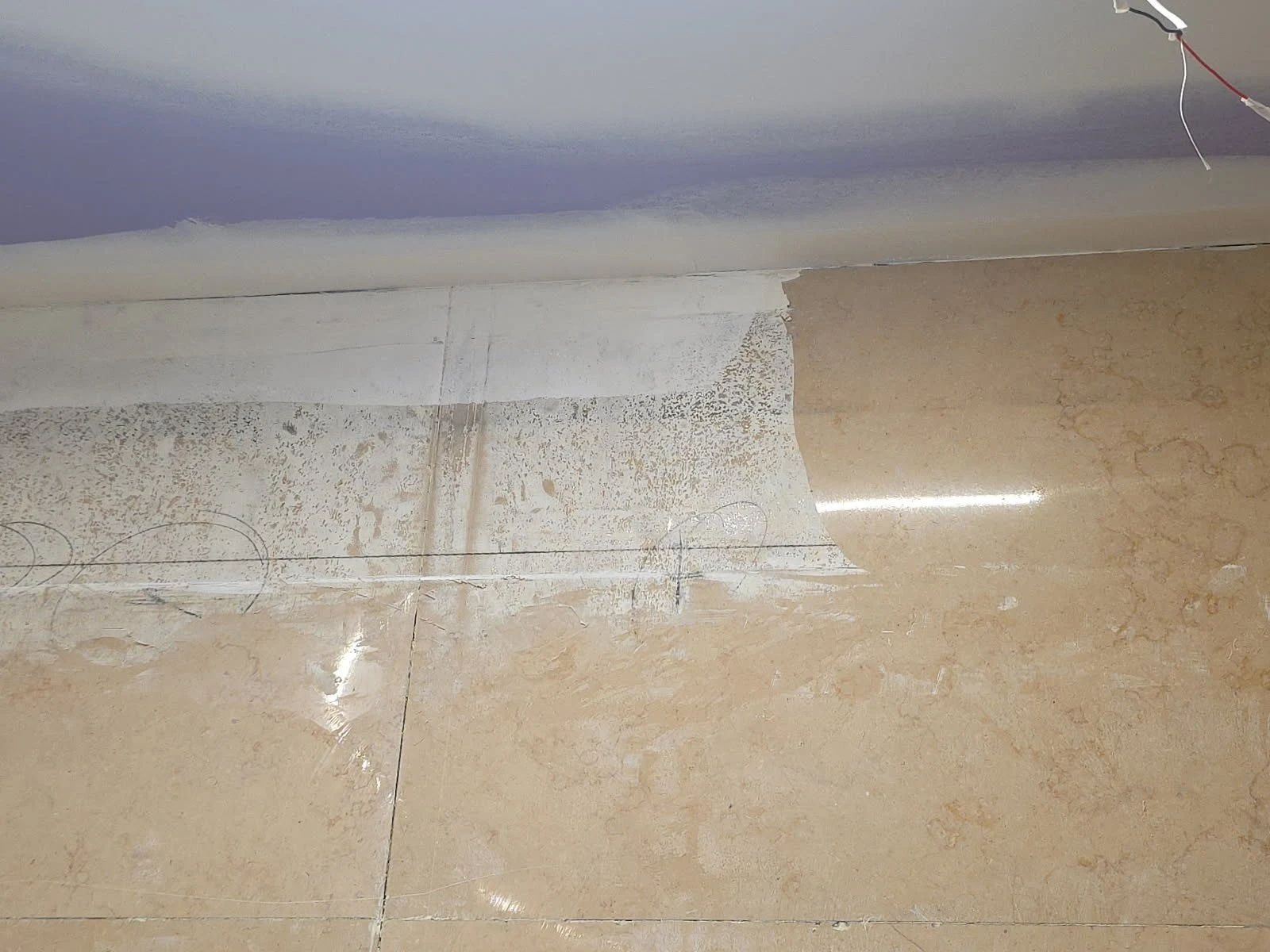 Close-up showing a change in marble surface condition during restoration